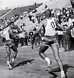 Charlie Mays awaits a baton transfer
from teammate Edwin Skinner.