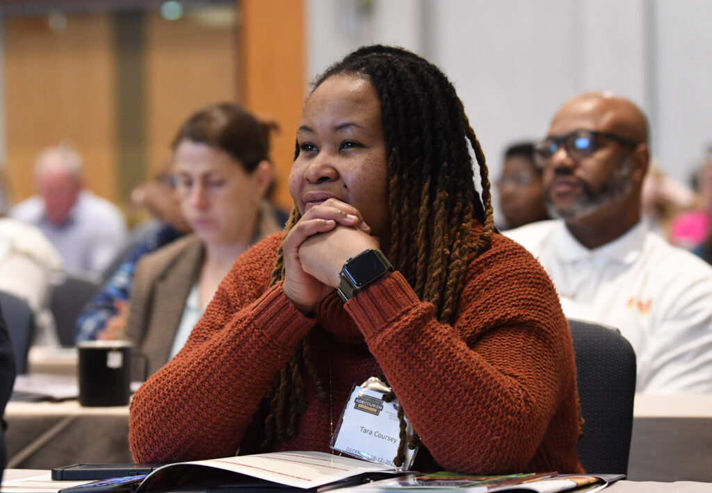 An Agritourism Conference attendee listens to a presentation.