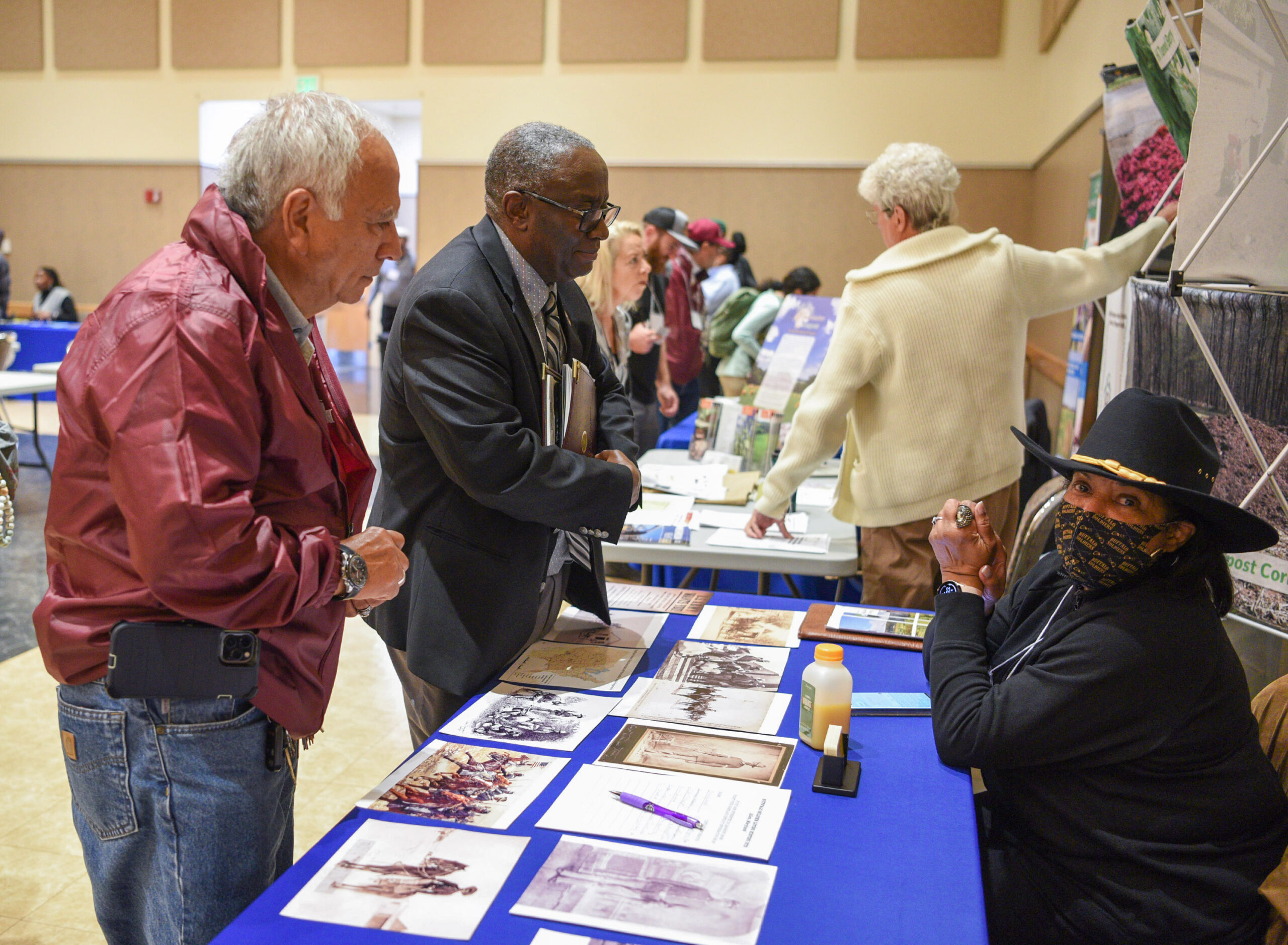 Dr. Enrique Escobar, left, Associate Dean for Extension and Dr. Moses Kairo, Dean of the School of Agricultural and Natural Sciences at UMES talks with Deborah Scott, project manager for the Buffalo Soldier Living Historic Site during the 19th Annual Small Farms Conference.