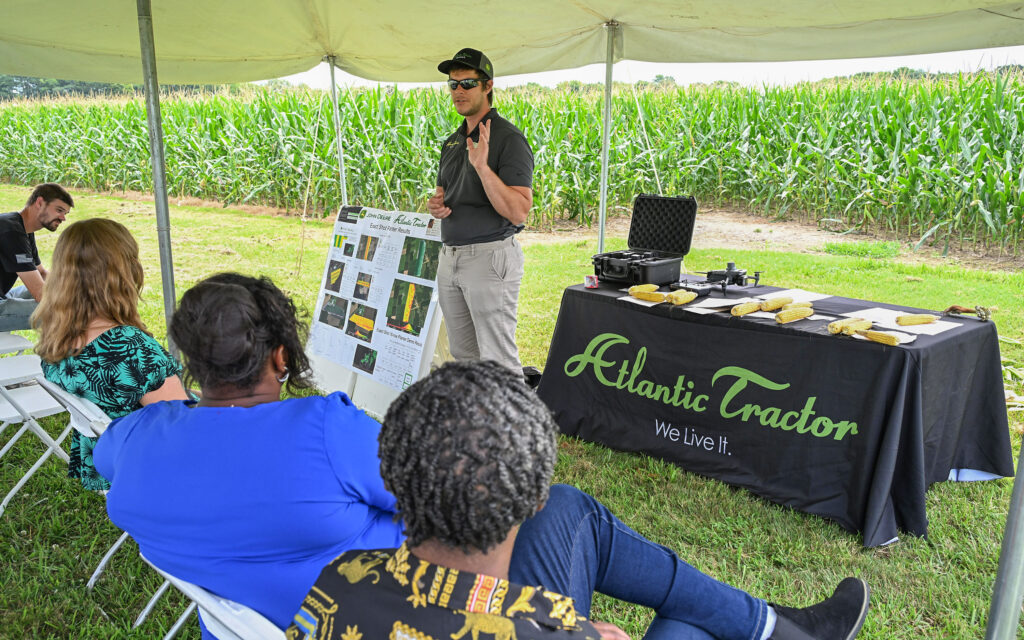 An Atlantic Tractor representative talks to Ag Showcase visitors.