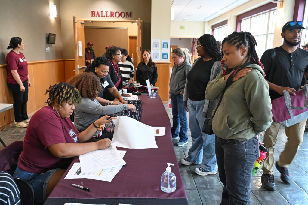 Volunteers man the check-in table at the 21st Small Farm Conference.