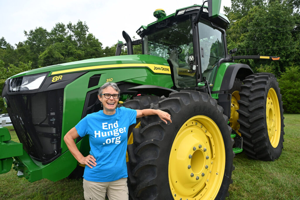 Jean Siers of Salisbury stands next to a tractor at the fifth annual Ag Showcase in August 2025.