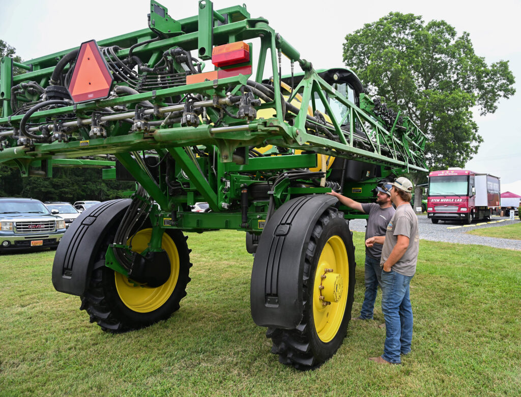 Brothers Austin and Aaron Meredith check out farm equipment on display at 2025 Ag Showcase.