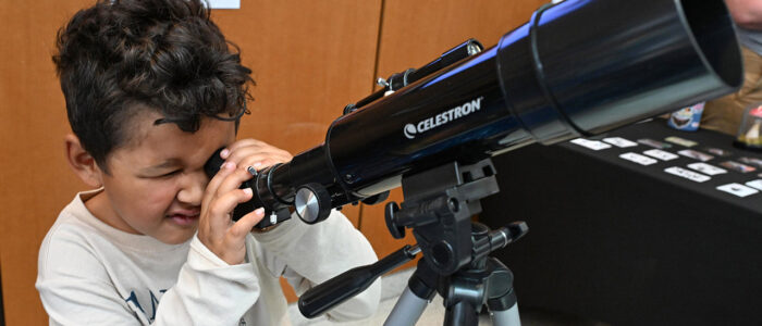 Jackson Handy, 5, of Princess Anne uses a telescope during the 2025 UMES 4-H STEM Expo.