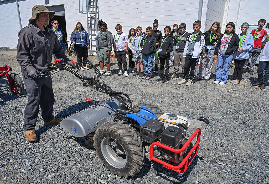 Dutch Harbour of UMES Extension demonstrates a small farm equipment to Somerset County students.