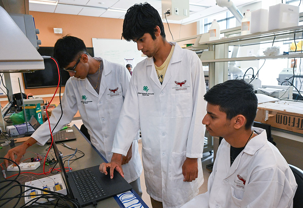 UMES 4-H Stem High School interns work on an experiment investigating the radiative cooling properties of cellulose materials.