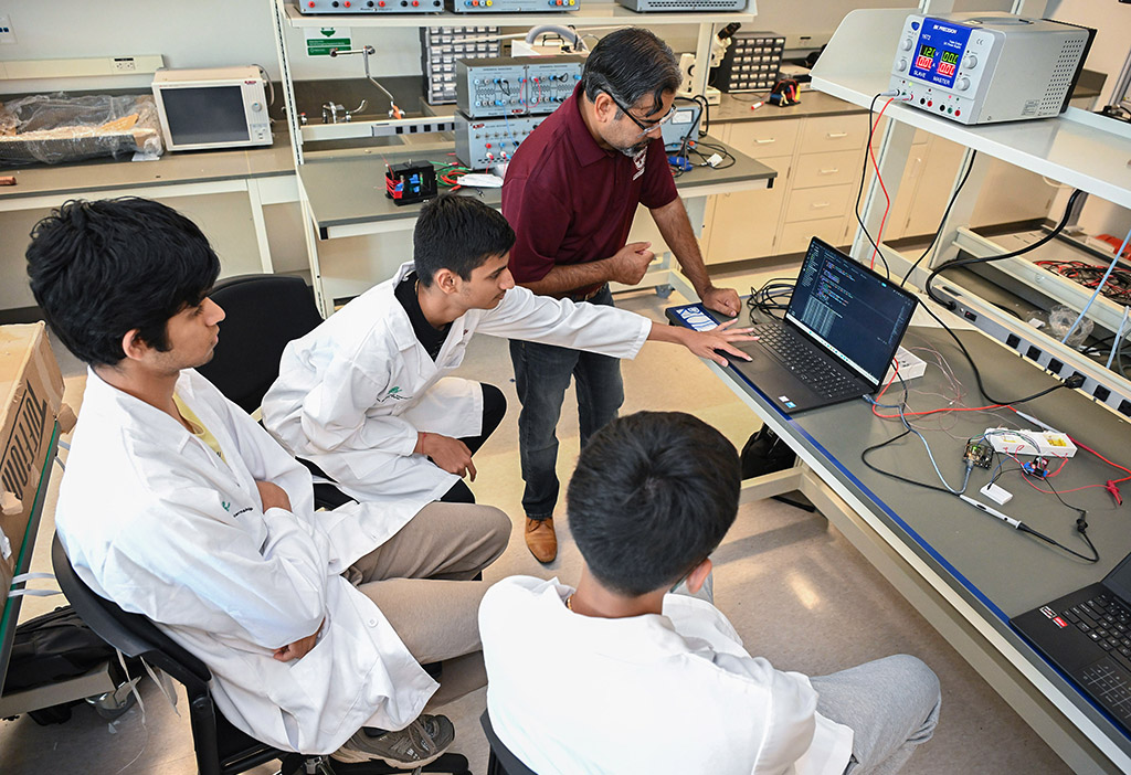 UMES 4-H Stem High School interns work on an experiment with Dr. Aaron Persad.