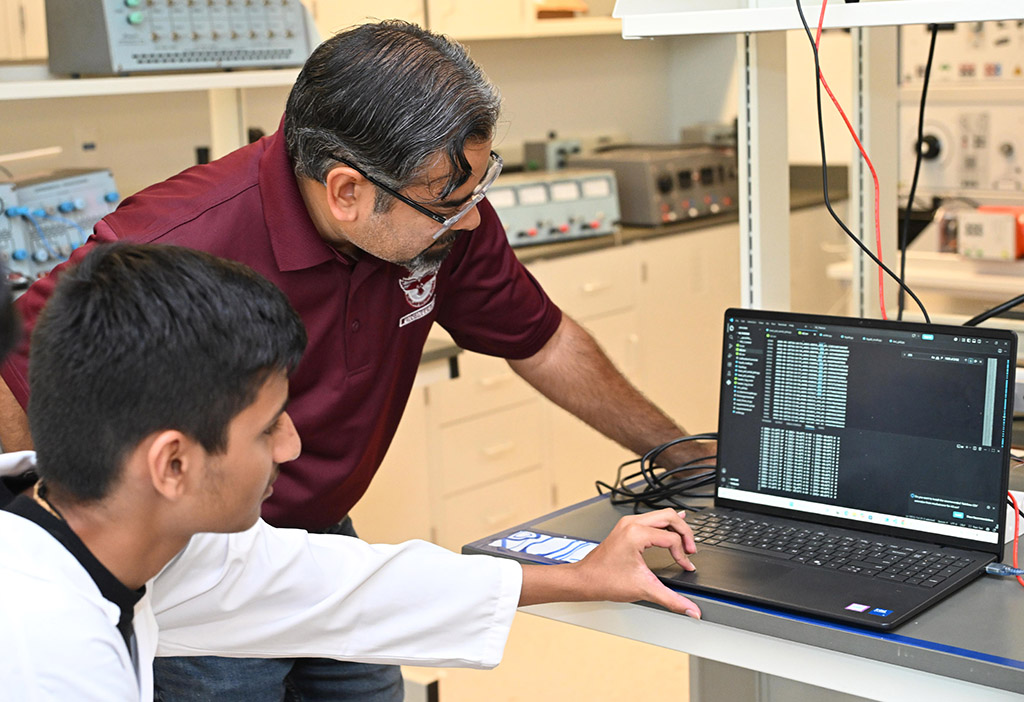 UMES 4-H Stem High School intern Rudra Patel works on an experiment with Dr. Aaron Persad.