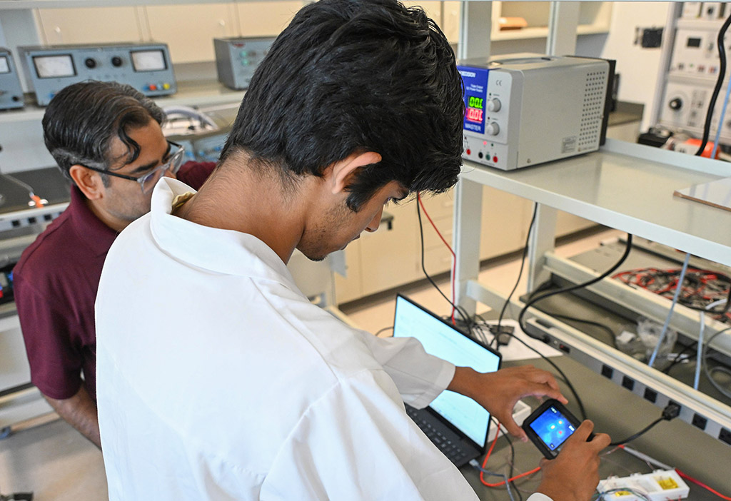 UMES 4-H Stem High School intern Bornil Das works on an experiment with Dr. Aaron Persad.