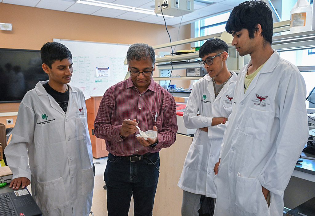 UMES 4-H Stem High School interns work on an experiment with Dr. Kausiksankar Das.