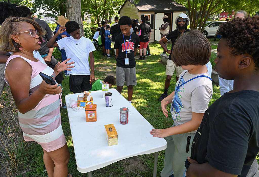UMES EFNEP instructor Dionne Ray teaches about different types of tea and plants to students from Camp SLAM at the Todd Family Community Garden in Princess Anne.