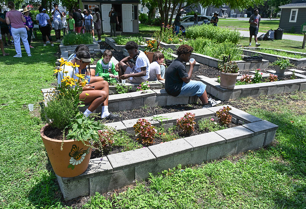Students from Camp SLAM work at the Todd Family Community Garden in Princess Anne.