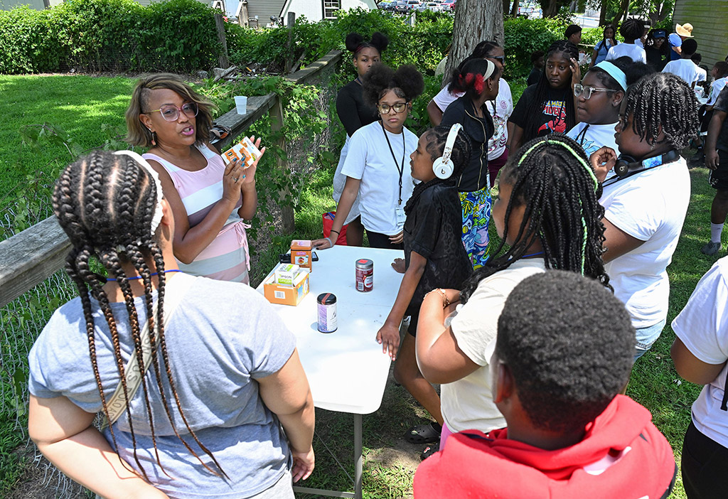 UMES EFNEP instructor Dionne Ray teaches about different types of tea and plants to students from Camp SLAM.