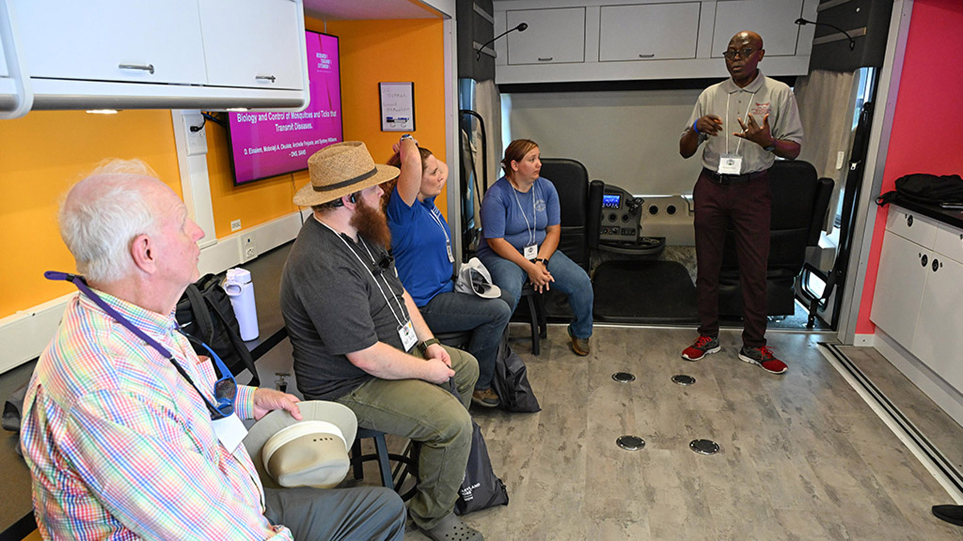 TGD-agshowcaseSTEM-2252 UMES Professor Mobolaji Okulate talks about mosquito research inside the 4-H Mobile STEM Lab at 2026 Ag Showcase.
