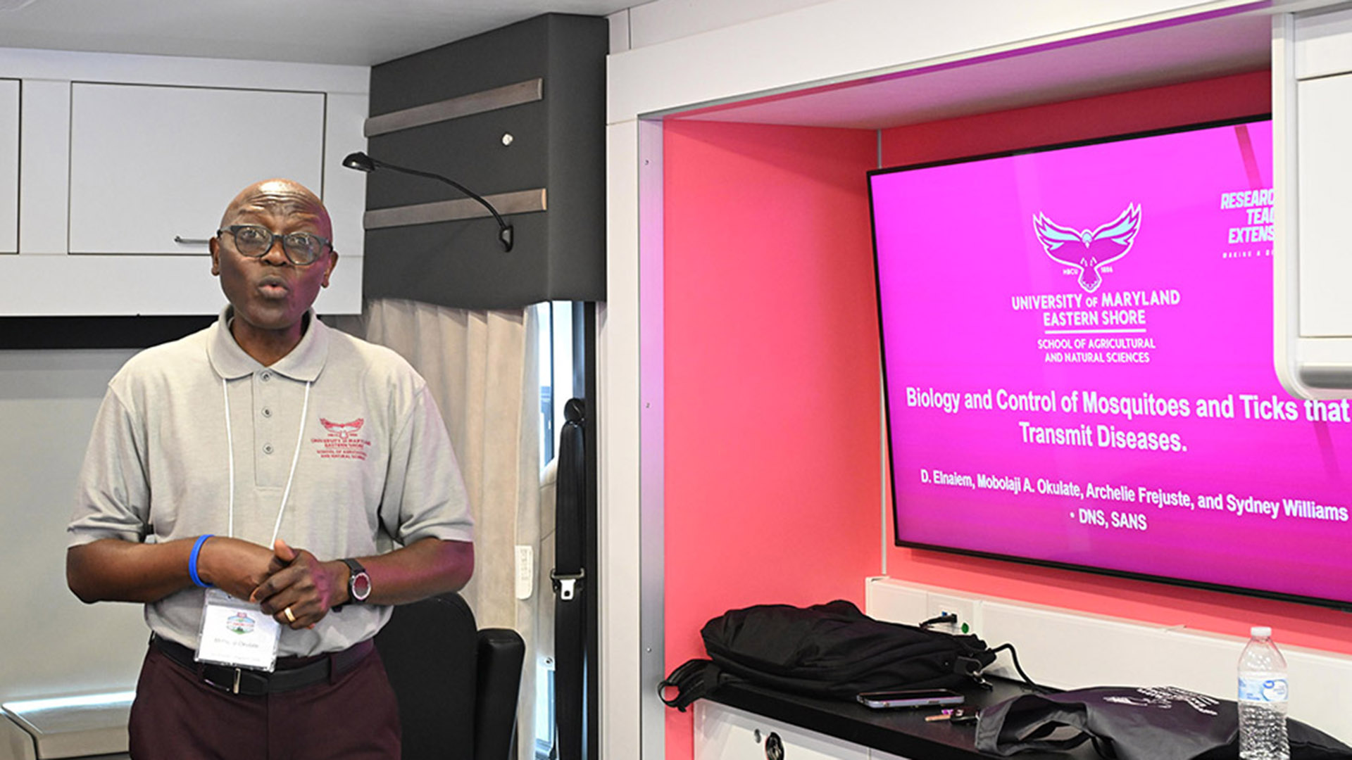 TGD-agshowcaseSTEM-2266 UMES Professor Mobolaji Okulate talks about mosquito research inside the 4-H Mobile STEM Lab at 2026 Ag Showcase.