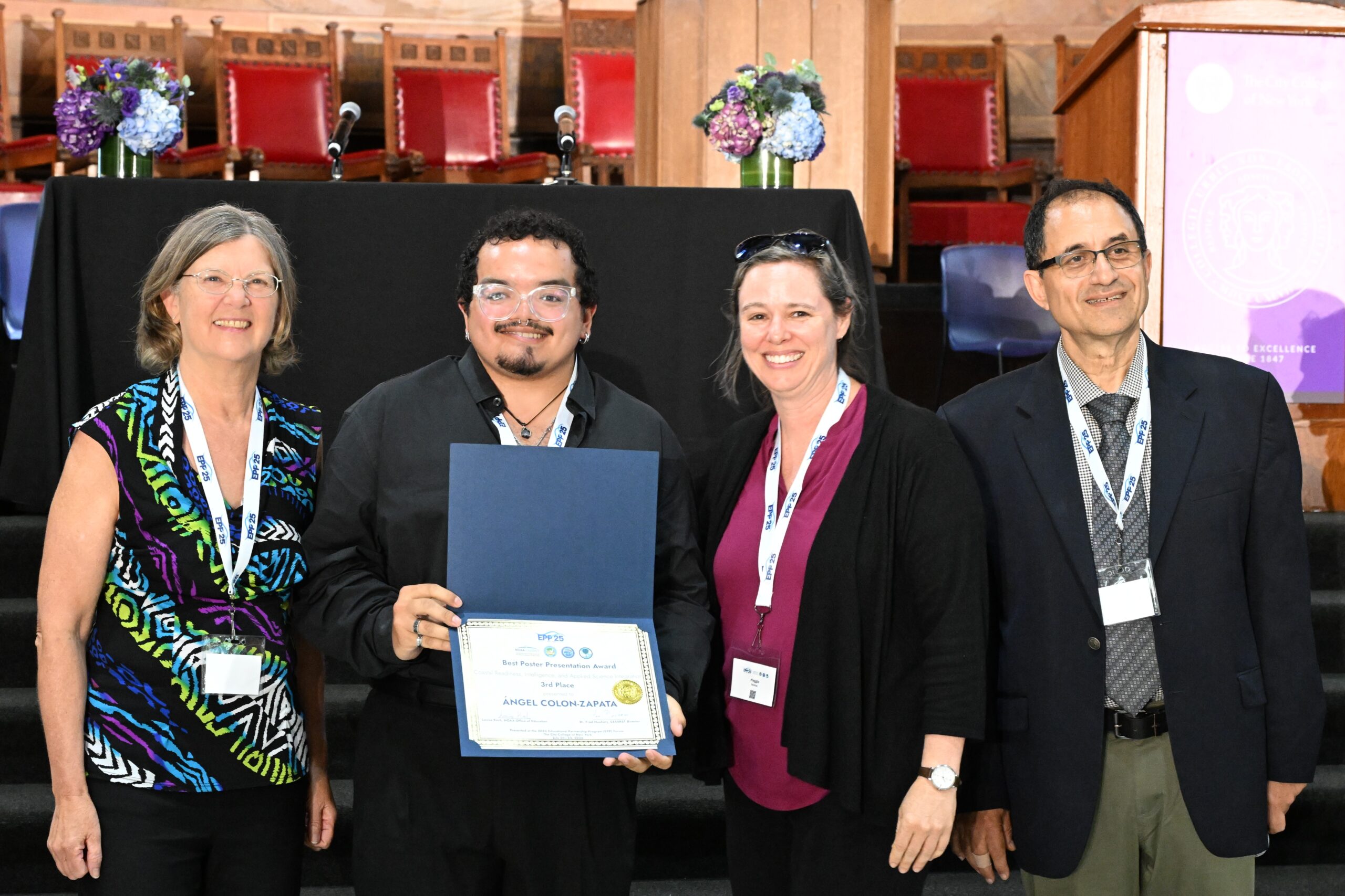 NOAA LMRCSC Fellow Angel Colon-Zapata (second from left) wins an award for his research poster presentation.