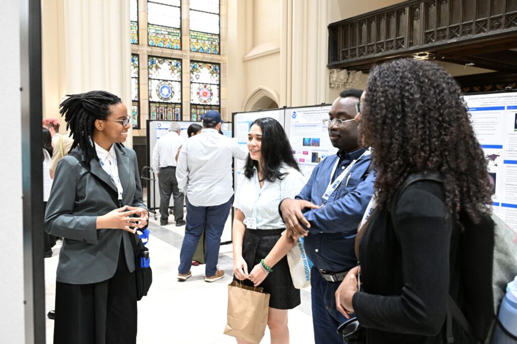 NOAA LMRCSC Fellow Nylah McClain (left) shares her research poster with Fellow Veronica Lucchese (center), Dr. Abiodun Omotayo (second from right), and Fellow Kayla Adams (right) at the 2026 NOAA EPP Biennial Education & Science Forum.