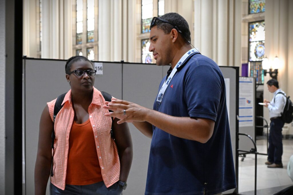 LMRCSC Fellow Daenen Jones (right) presents his research poster to Alum and NOAA Fisheries Biologist Dominique Lazarre (left) at the 2026 NOAA EPP forum.