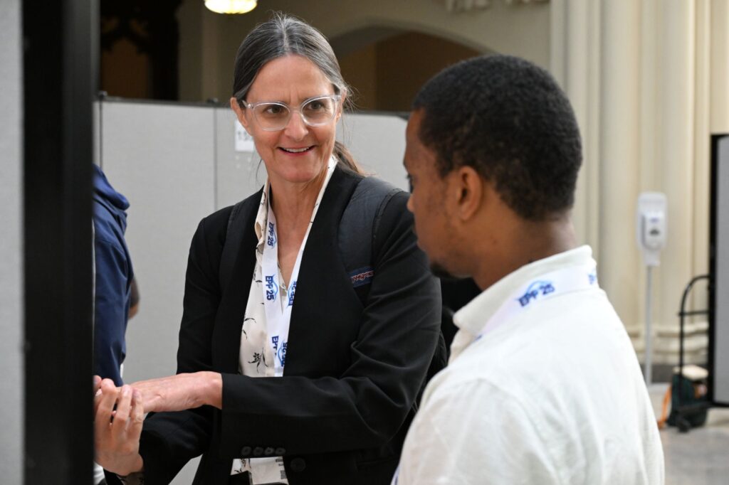 NOAA LMRCSC Faculty member Dr. Elizabeth Babcock talks to Fellow Aaron Pickett about  his research poster at the 2026 NOAA EPP Biennial Education & Science Forum.