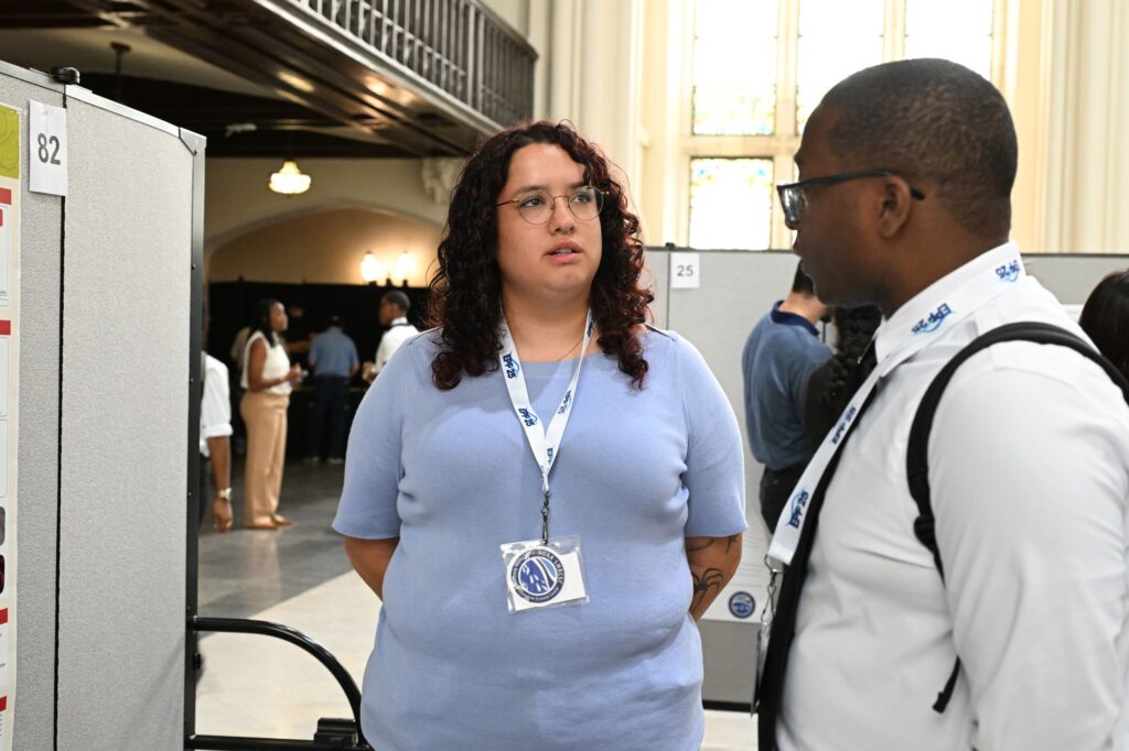 NOAA LMRCSC Fellow Lady Volmar talks to Alum Teemer Barry about her research poster at the 2026 NOAA EPP Biennial Education & Science Forum.