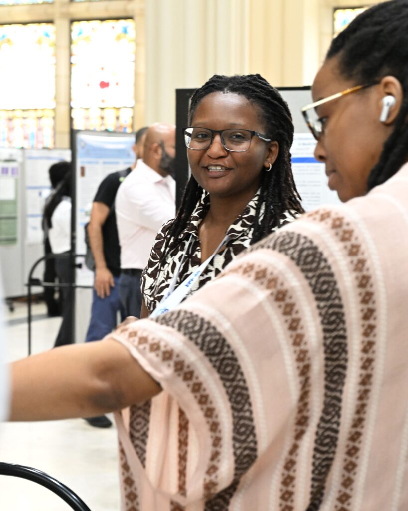 NOAA LMRCSC Fellow Allissa Riley (left) presents her research poster to Fellow Nylah McClain at the 2026 NOAA EPP forum.