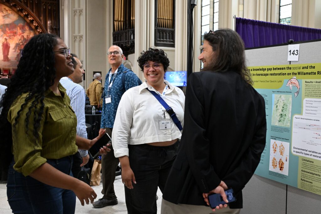 NOAA LMRCSC Fellow Alexis Griffin (center) presents a research poster at the 2026 NOAA EPP forum.