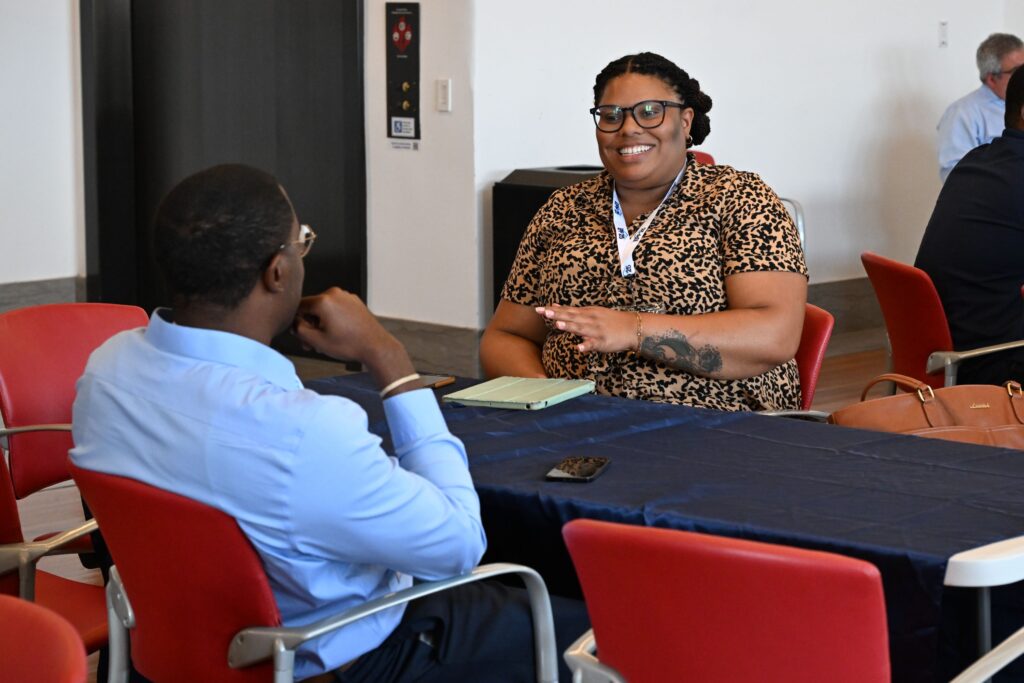 NOAA LMRCSC Fellow Kayland Huckaby gets one-on-one career advice from a NOAA scientist at the 2026 NOAA EPP Education & Science Forum.