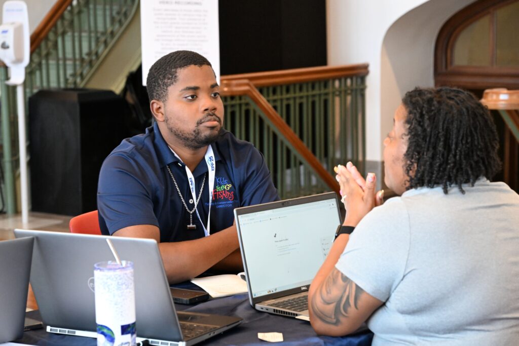 NOAA LMRCSC Fellow Chryston Best-Otubu gets one-on-one career advice from a NOAA scientist at the 2026 NOAA EPP Education & Science Forum.