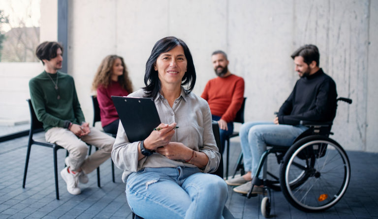 M.S. in Rehabilitation Counseling—facilitator leading a small group discussion in a counseling setting.