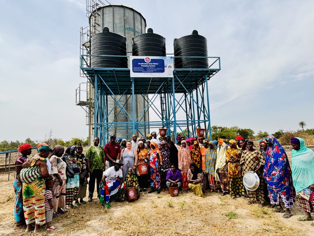 U.S. Embassy Deputy Chief of Mission Rebecca Taylor and South Carolina State's Dr. Lamin Drammeh join the Illiassa Women Garden Kafo to celebrate opportunities in sustainable farming.