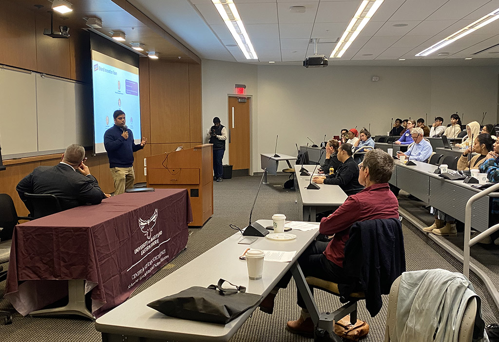 A speaker from Perdue Farms talks about research at the Center for Student Excellence's second Student-led Undergraduate Research Symposium in December 2025.