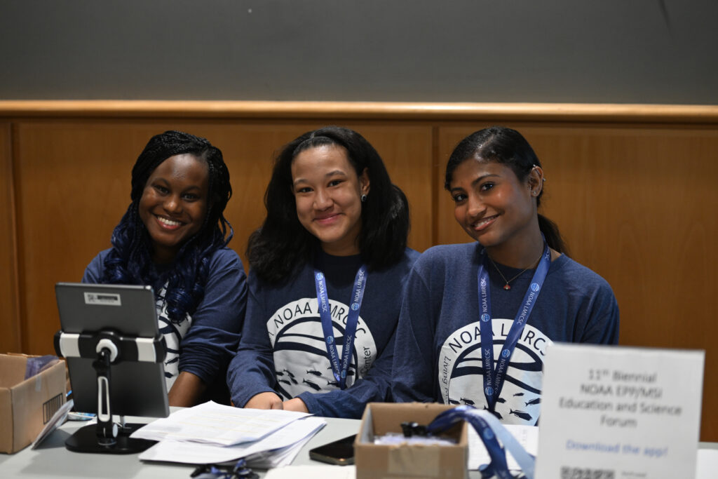 From left, UMES students and NOAA LMRCSC fellows Cali Roberts, Ashley Duran and Nina Clovis help registrants check in. Photo by FotoJoe Photography.
