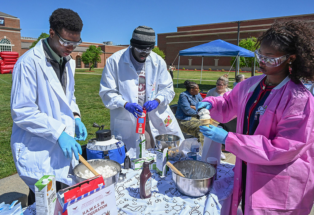 Members H.A.W.K.S. in Configuration club make ice cream from dry-ice during the annual DASL Expo.