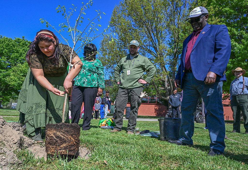 ESA Club member Mel Montoya plants a Hackberry tree during the UMES Earth Day celebration.