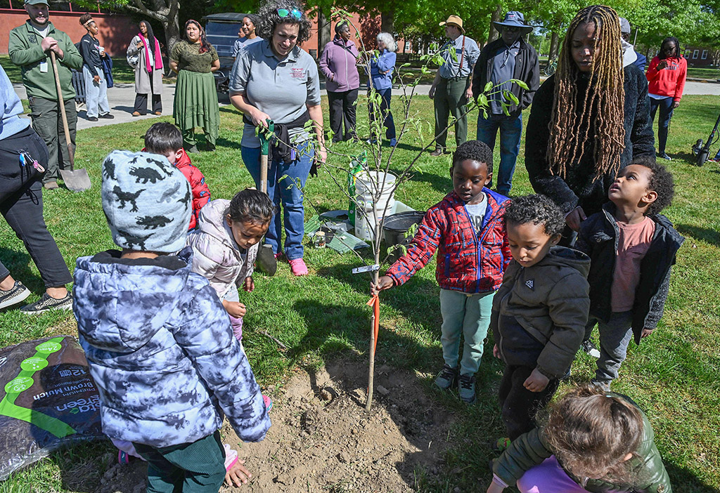 Children from the UMES Child and Family Development Center help plant a tree during the UMES Earth Day celebration.