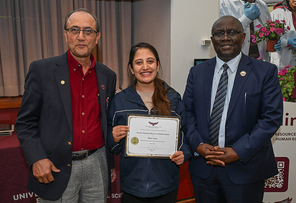 Award winner Raksha Khadka, center, with Dean Dr. Moses T. Kairo and Dr. Lila Karki.
