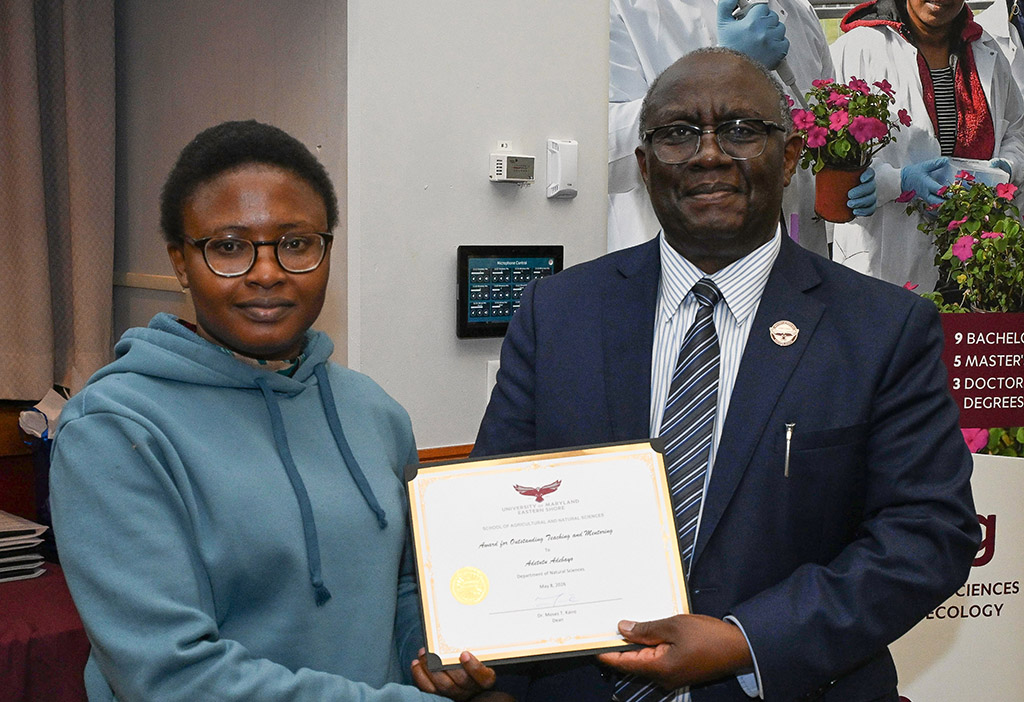 Adetutu Adebayo receives award from Dean Dr. Moses T. Kairo at SANS end of the year awards event.