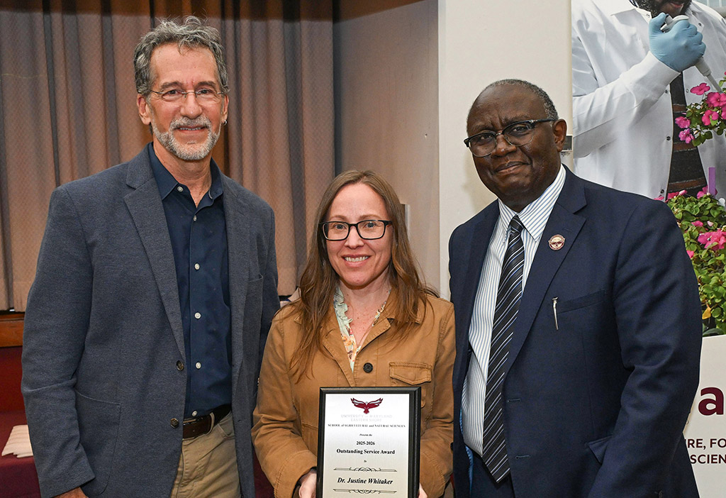 Department of Natural Sciences Outstanding Service Award winner Dr. Justine Whitaker with Dean Dr. Moses T. Kairo and Chair Dr. Jonathan Cumming.