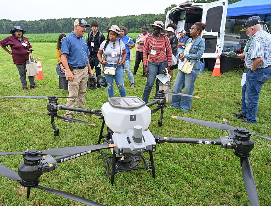 A drone company representative demonstrates an agricultural drone at UMES' 2025 Ag Showcase.