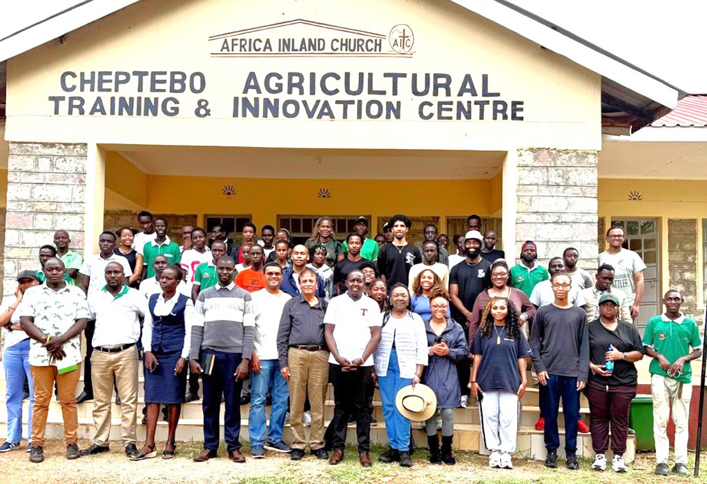 The FAMU delegation poses with staff and trainees of the AIC Cheptebo Rural Development Center during a visit to the center.