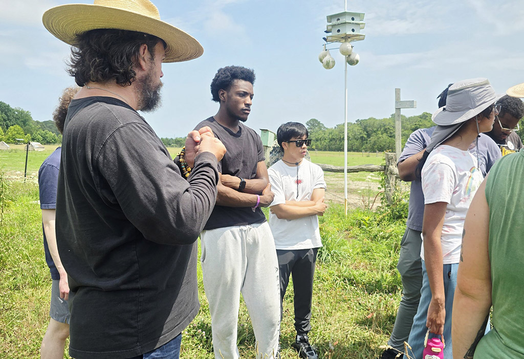 Stewart Lundy, co-owner of Perennial Roots Farm in Accomac, Virginia, talks to summer interns participating in UMES' Research and Extension Experiences for Undergraduates program funded by USDA NIFA.