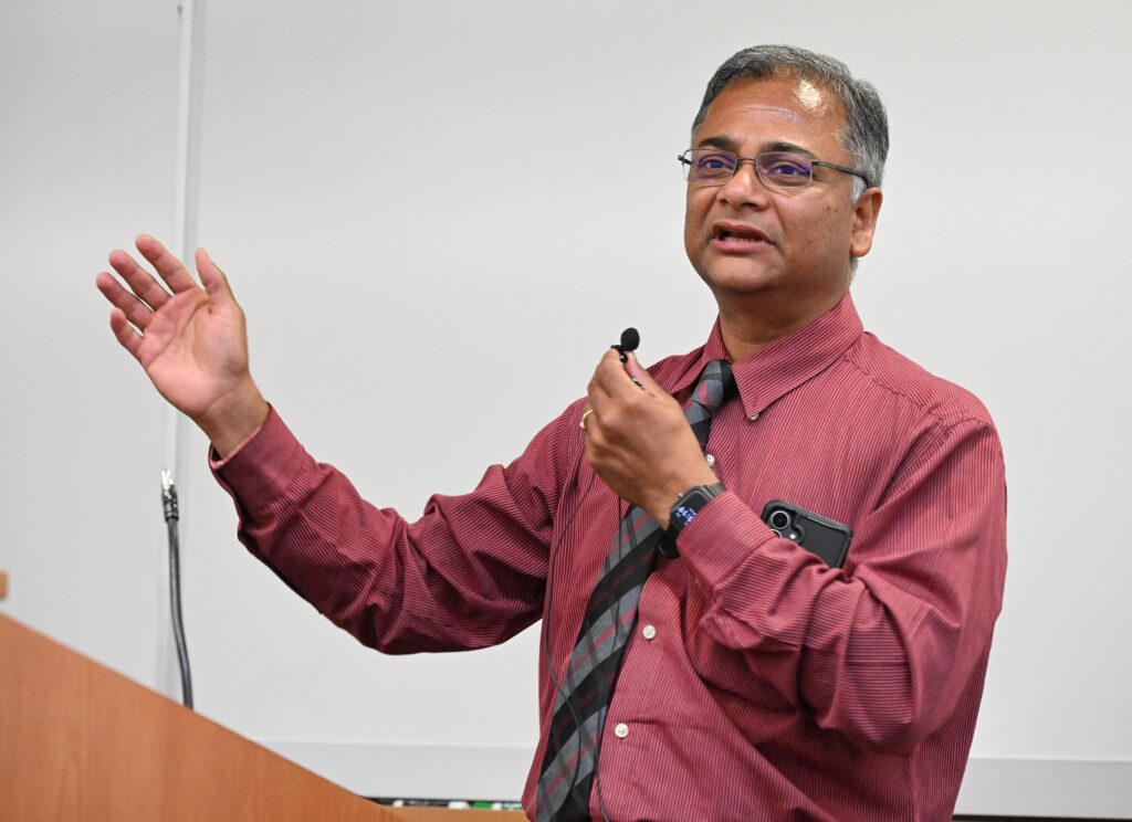 Kausik Das, physics professor and director of the SANS Center for Student Excellence, gives closing remarks at the 2026 Summer Research Symposium.