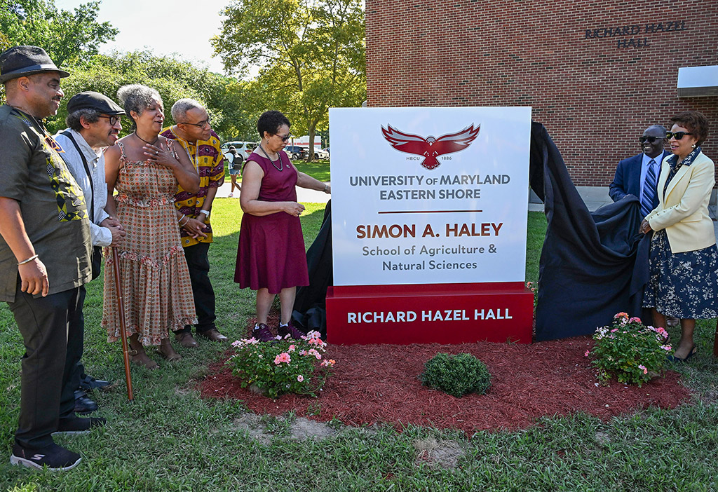 The Haley Family, from left, Bill Haley, Alan Haley, Anne Haley and Chris Haley, watch UMES President Heidi Anderson, left, pull the drape off the sign with the help of Moses Kairo, Dean of the School and Regent Yvette Lewis during the naming ceremony of the Simon A. Haley School of Agriculture & Natural Sciences on Tuesday, Sept. 8, 2026. (Photo by Todd Dudek, UMES Ag Communications)