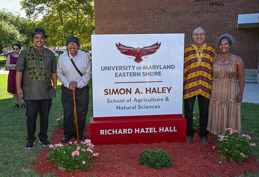 The Haley Family, from left, Bill Haley, Alan Haley, Chris Haley and Anne Haley, stands next to the newly unveiled school sign.