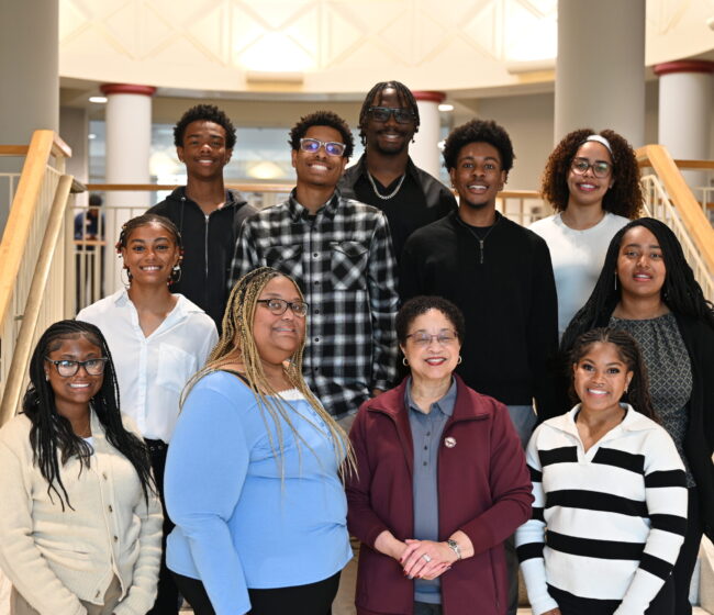 A group of HBCU STEM students pose with their institution president.