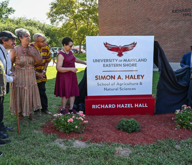 The Haley Family, from left, Bill Haley, Alan Haley, Anne Haley and Chris Haley, watch UMES President Heidi Anderson, left, pull the drape off the sign with the help of Moses Kairo, Dean of the School and Regent Yvette Lewis during the naming ceremony of the Simon A. Haley School of Agriculture & Natural Sciences on Tuesday, Sept. 8, 2026. (Photo by Todd Dudek, UMES Ag Communications)